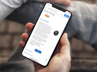 a person looking at the austin energy rush hour rewards on their iphone