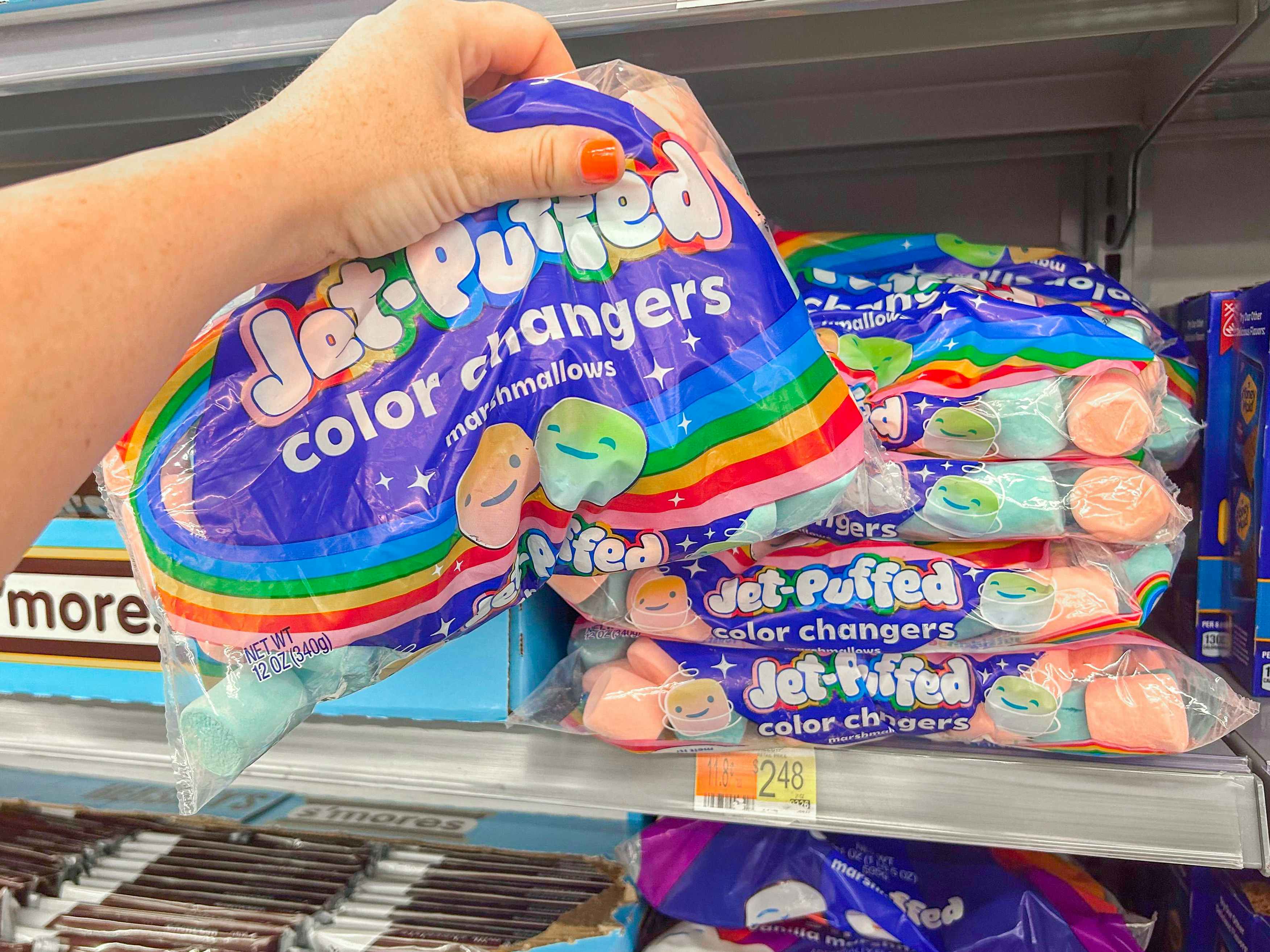 a hand holding up a bag of coloring changing marshmallows 