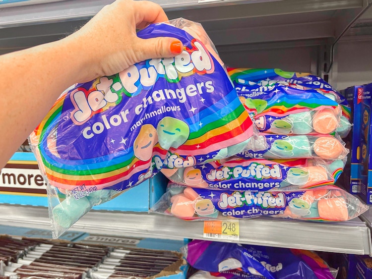 a hand holding up a bag of coloring changing marshmallows 