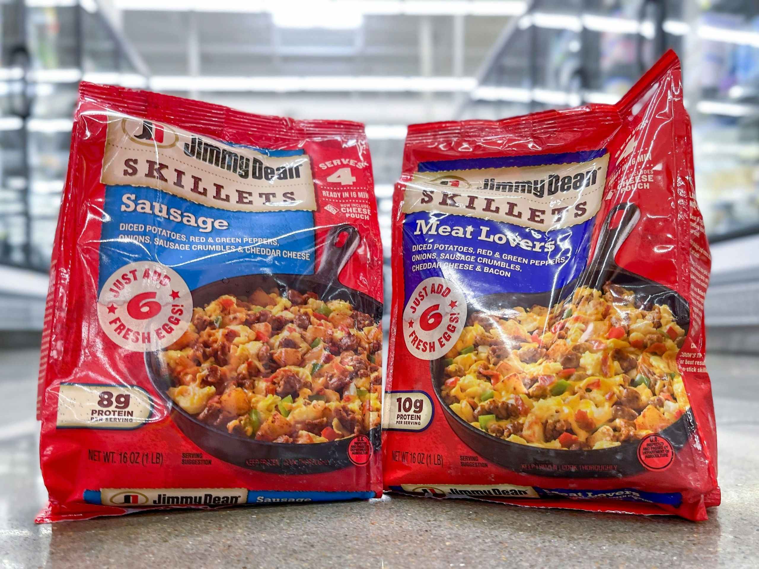 Two Jimmy Dean Skillet bags sitting on the floor in the middle of a store aisle.