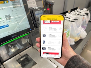 Hand holding a phone that shows the latest dishwasher coupons on KCL
