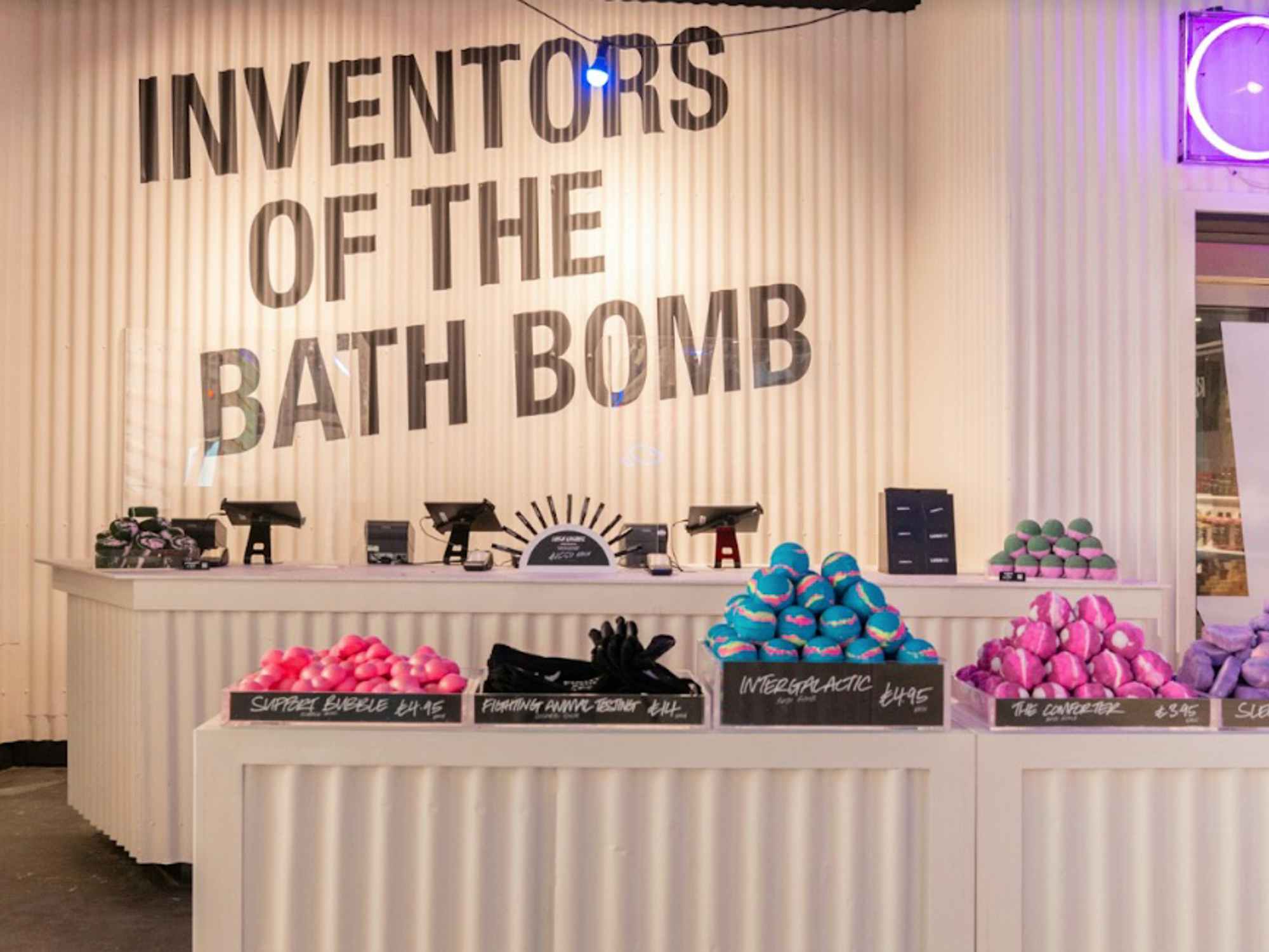 The counter in a Lush store with bath bombs on display