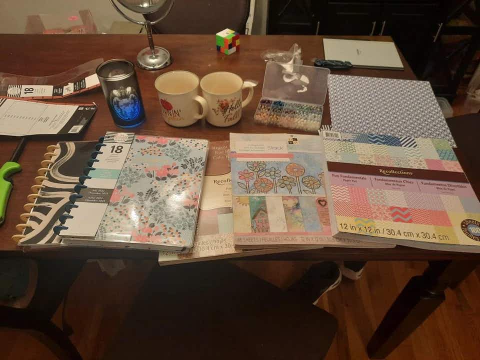 Some planners, paper products, candles, and beads found in a Michael's craft store dumpster