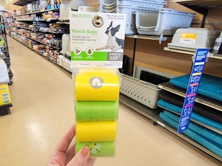 hand holding a pack of dog waste bags