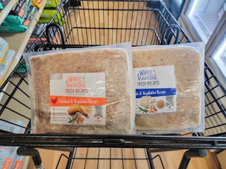 bags of fresh frozen dog food in a cart