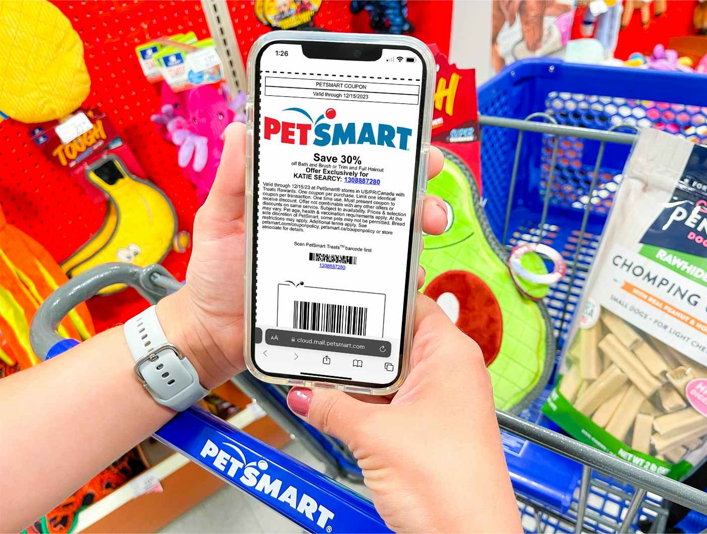 Person holding a phone showing the petsmart coupon