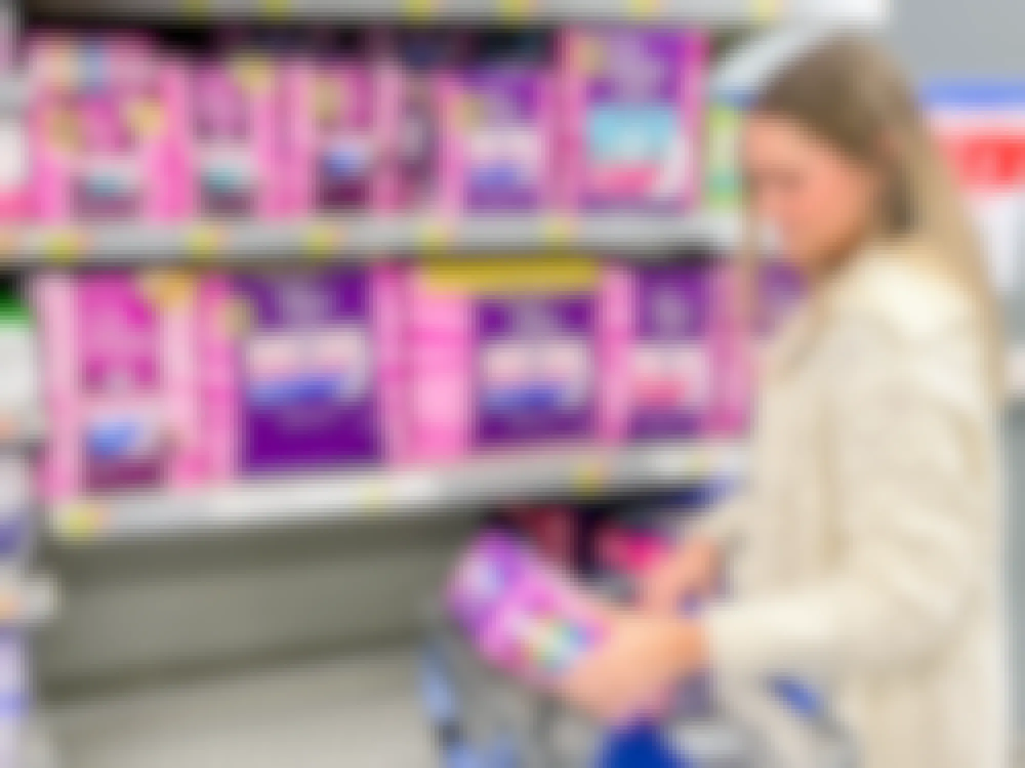 a person looking at poise pads in walmart