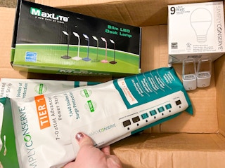 Someone looking through a box of freebies from a power company