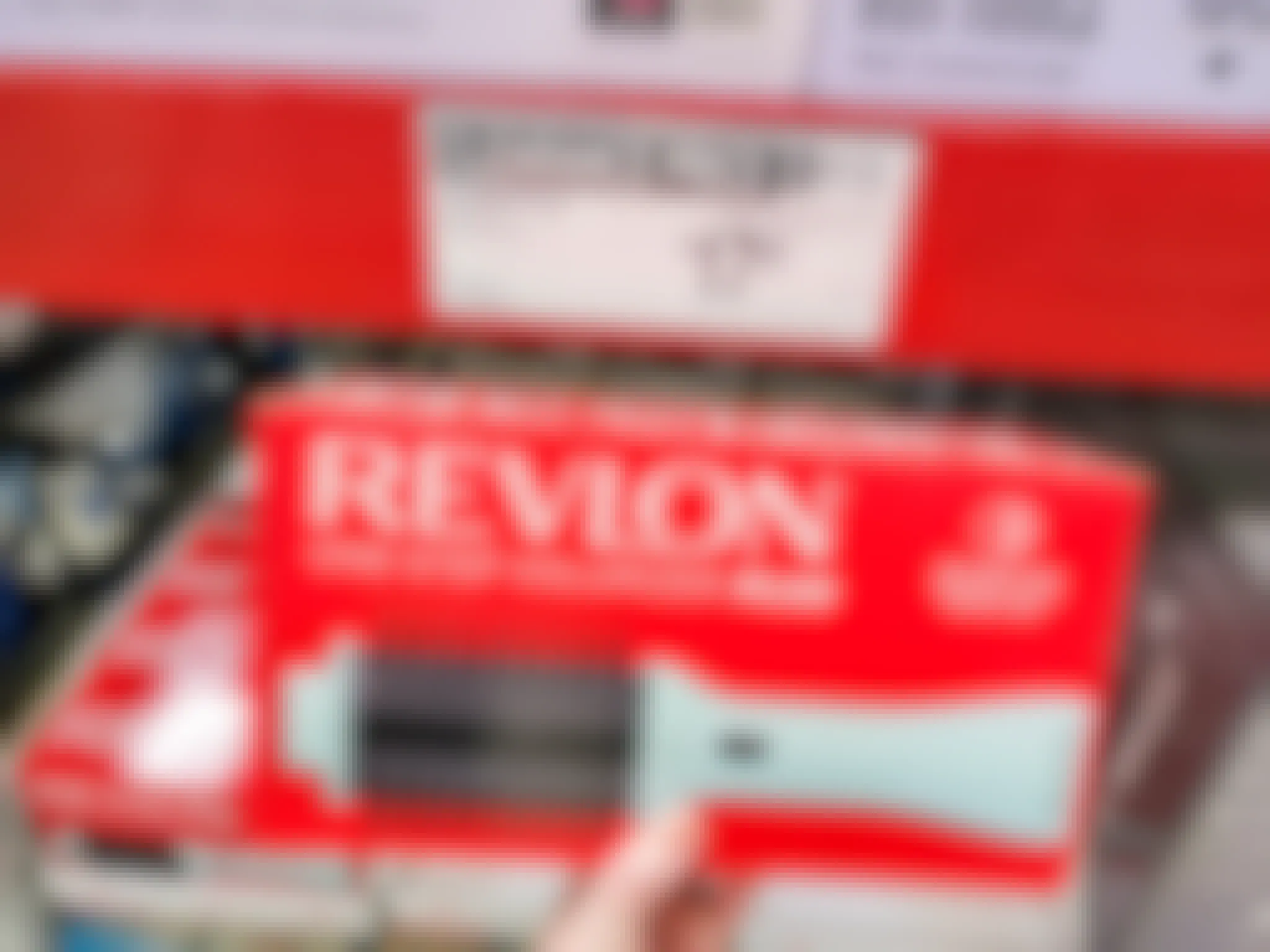 hand holding a revlon volumizer by a clearance sign for $17.81
