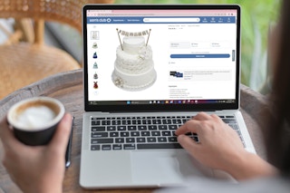 a person looking at a wedding cake on sams clubs website on a laptop