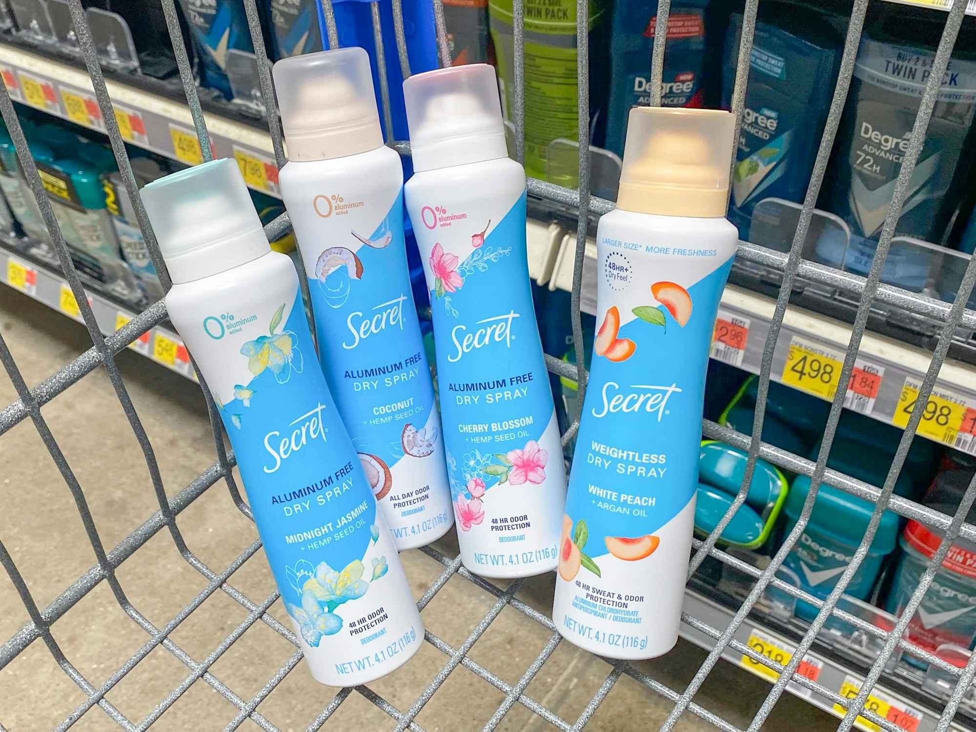 Some Secret Dry Spray deodorants in a Walmart shopping cart