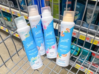 Some Secret Dry Spray deodorants in a Walmart shopping cart