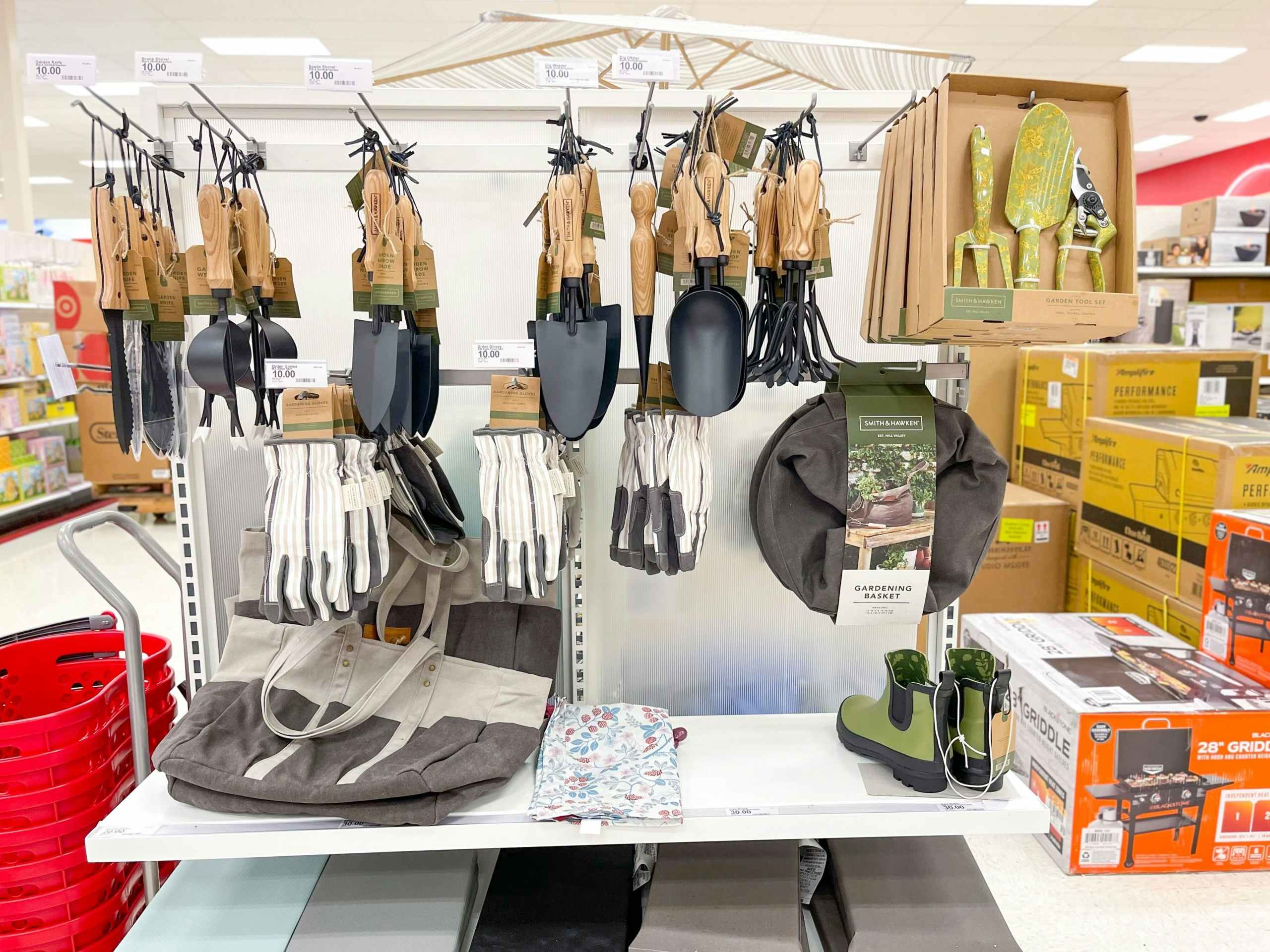 A variety of outdoor tools hanging from store racks and sitting on the store shelves.
