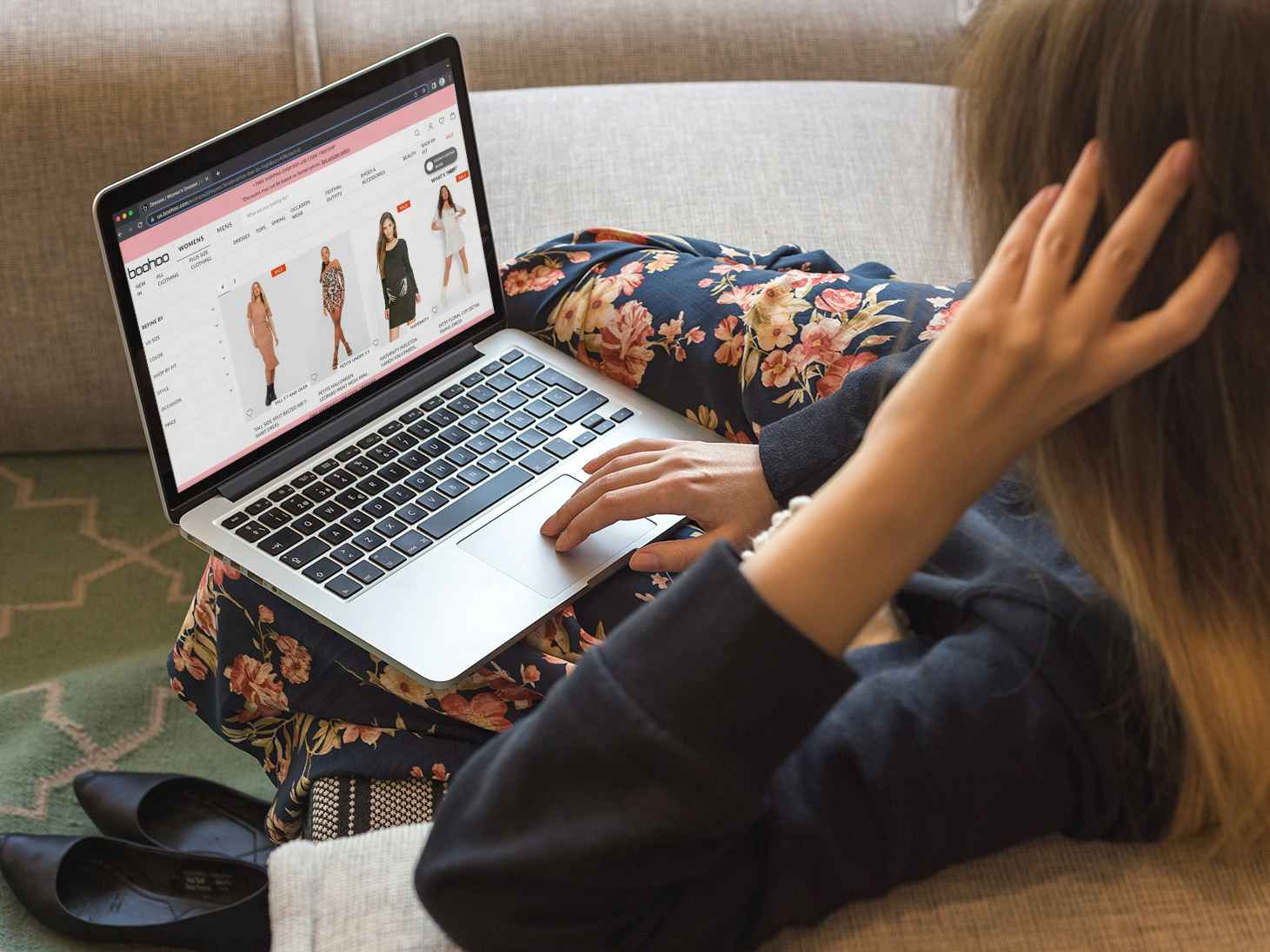 A person using a laptop to shop on the Boohoo website