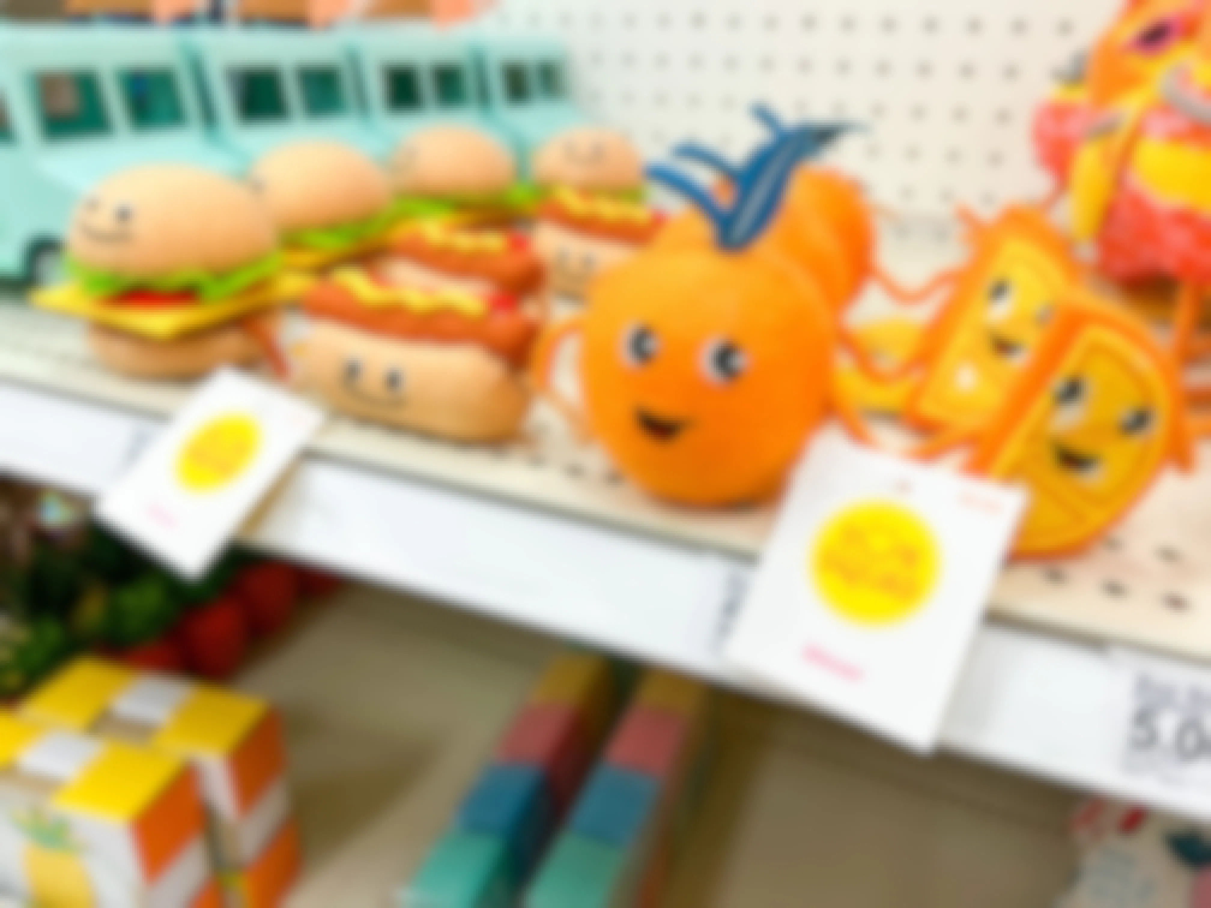 the hamburger and hot dog and the orange and orange slice felt duos on the shelf at Target