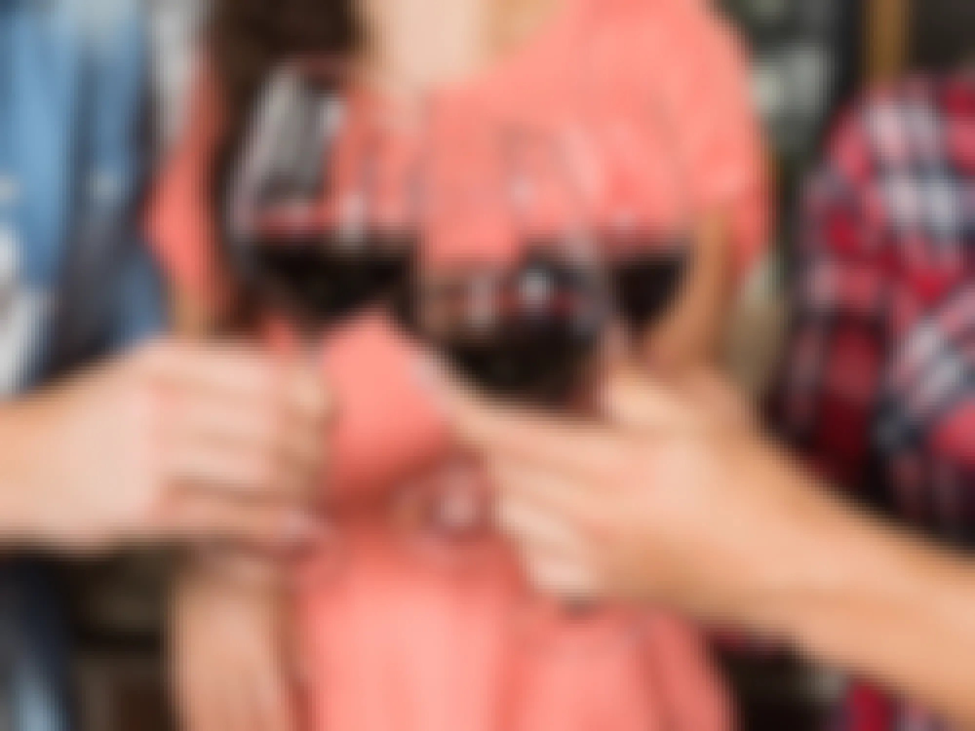 people holding wine glasses half filled with wine