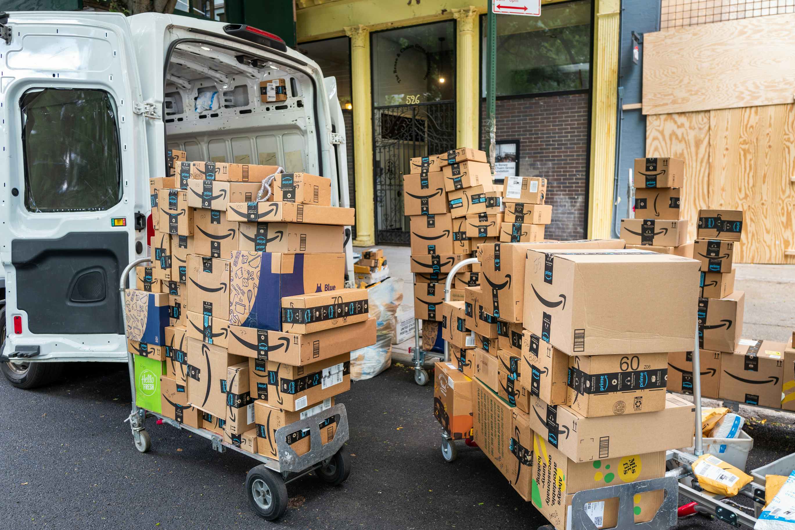 amazon boxes on dollies coming out of a delivery cargo van