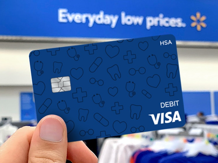 person holding a visa debit hsa card in walmart store