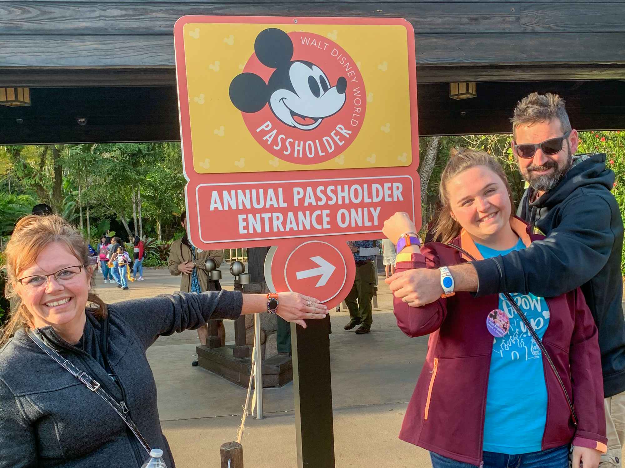 people standing in front of the annual pass holder entrance at walt disney world