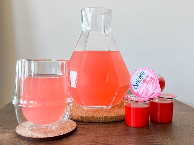Splenda pull and pour pink lemonade mixed into a carafe and glass