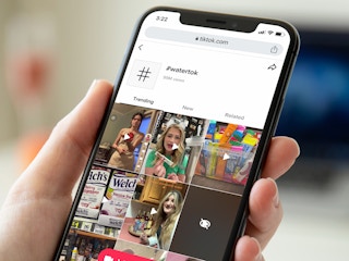 person holding phone and looking at #watertok hashtags on tiktok app screenshot
