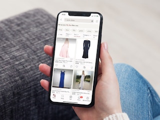 a person looking at the poshmark app on their iphone