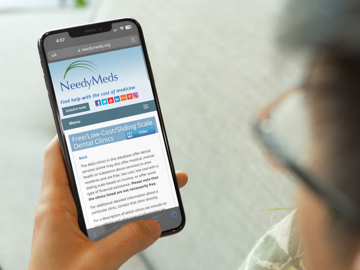 Someone looking at the NeedyMeds website on their phone