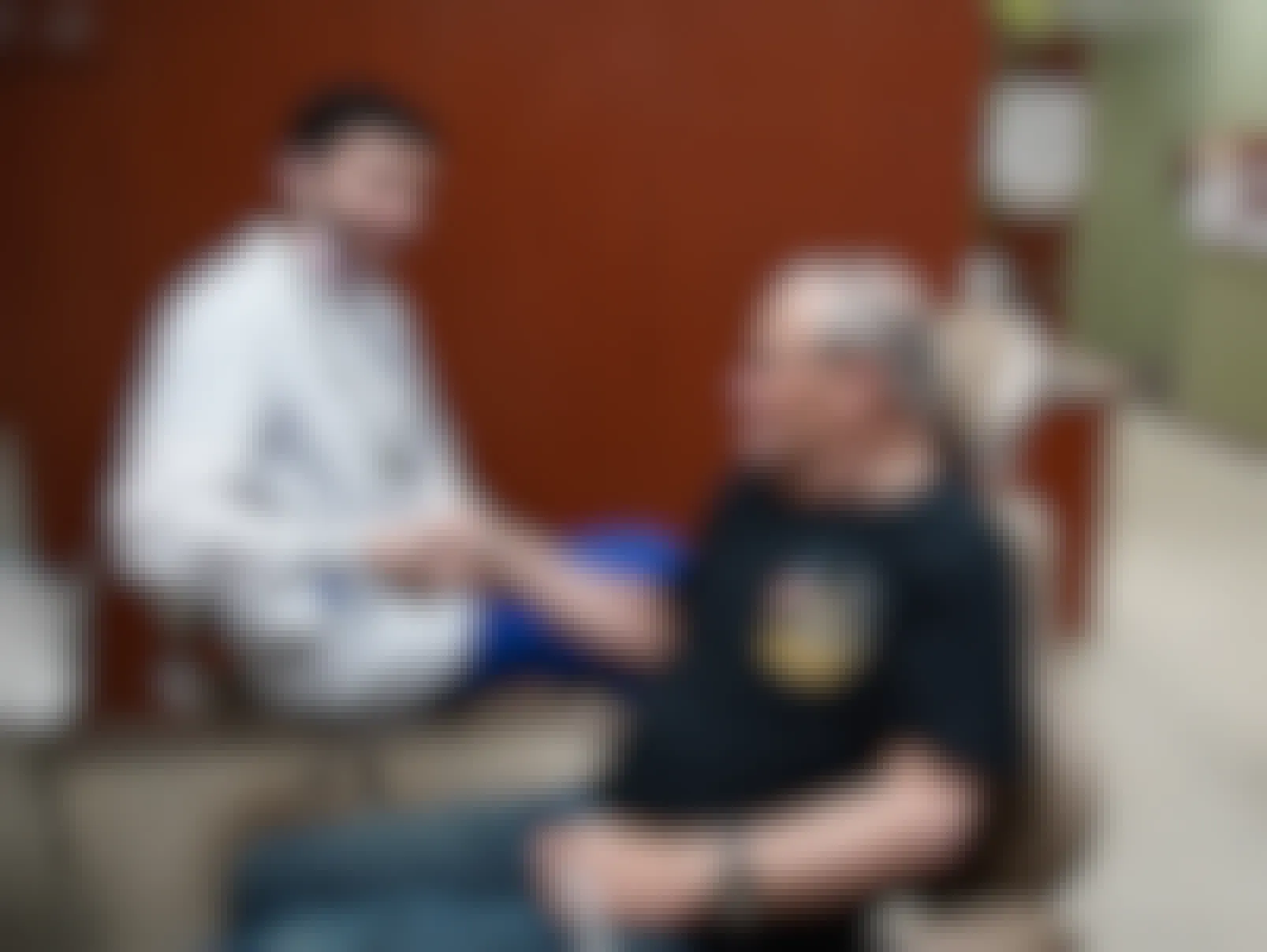 A dentist shaking the hand of a military veteran in sitting in their office