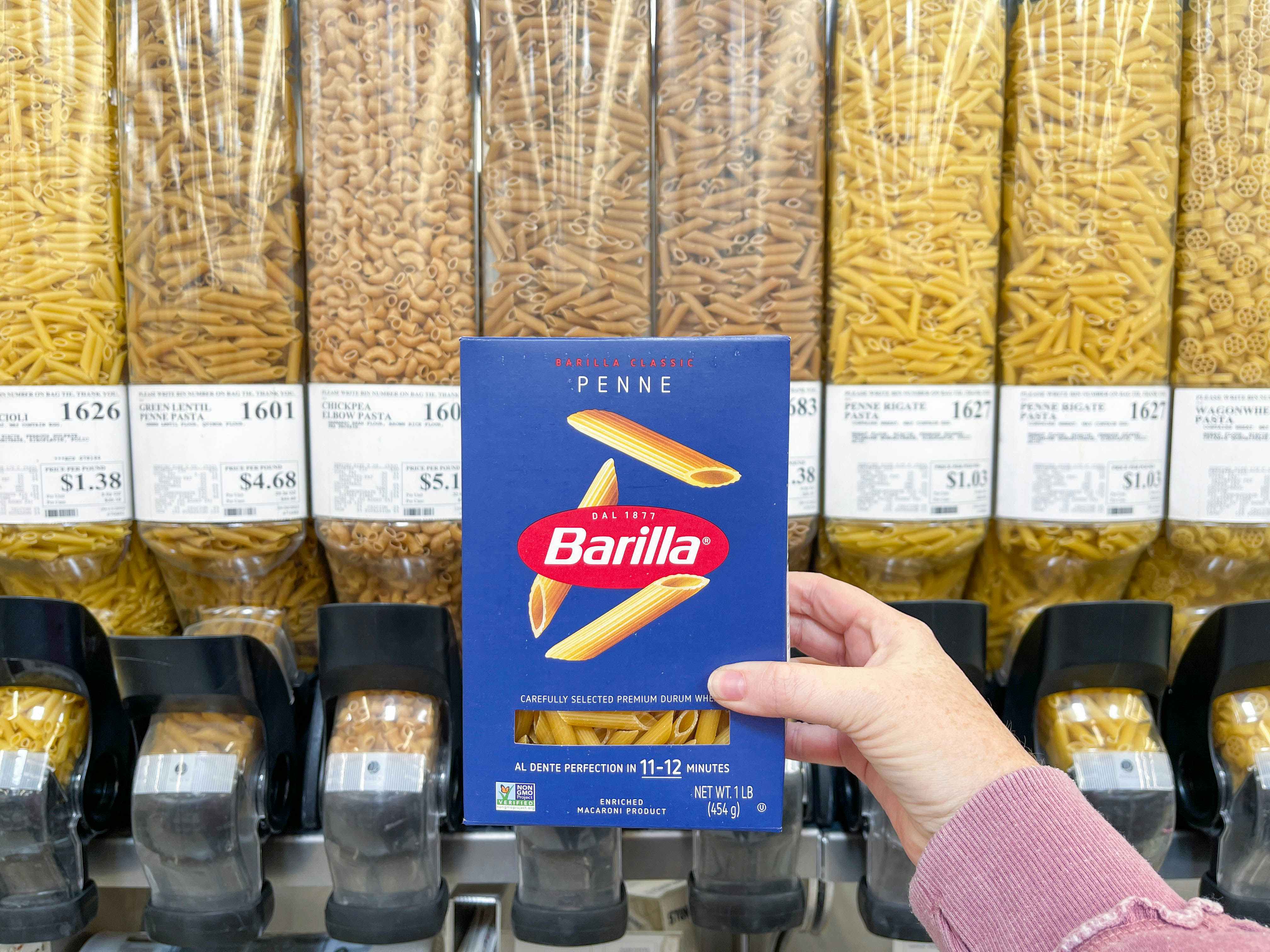 a package of pasta being held in front of winco bulk foods