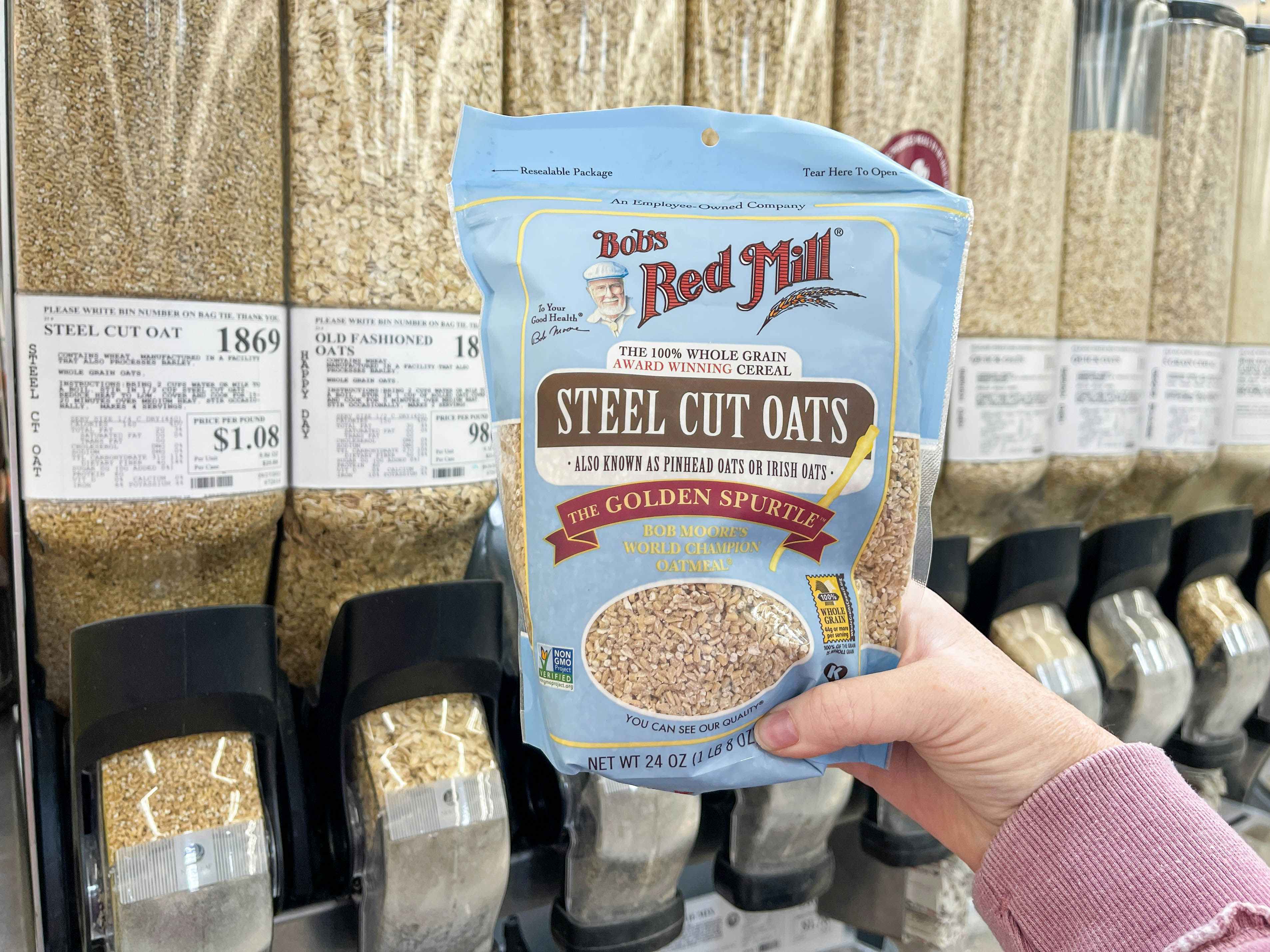 a package of steel cut oats being held in front of winco bulk foods