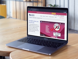 A laptop displaying the Florida Prepaid website offer for a $50 bonus with 529 account enrollment