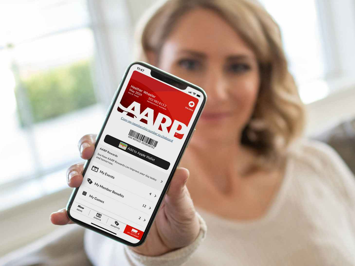 person showing their digital aarp membership screen on a phone