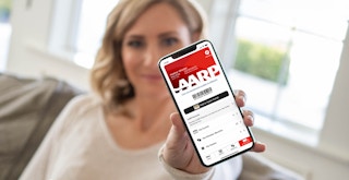 person showing their digital aarp membership screen on a phone