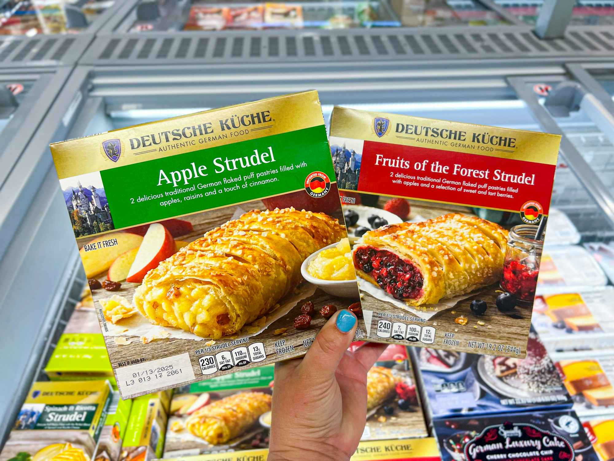 Someone holding apple and fruits of the forest strudels at Aldi