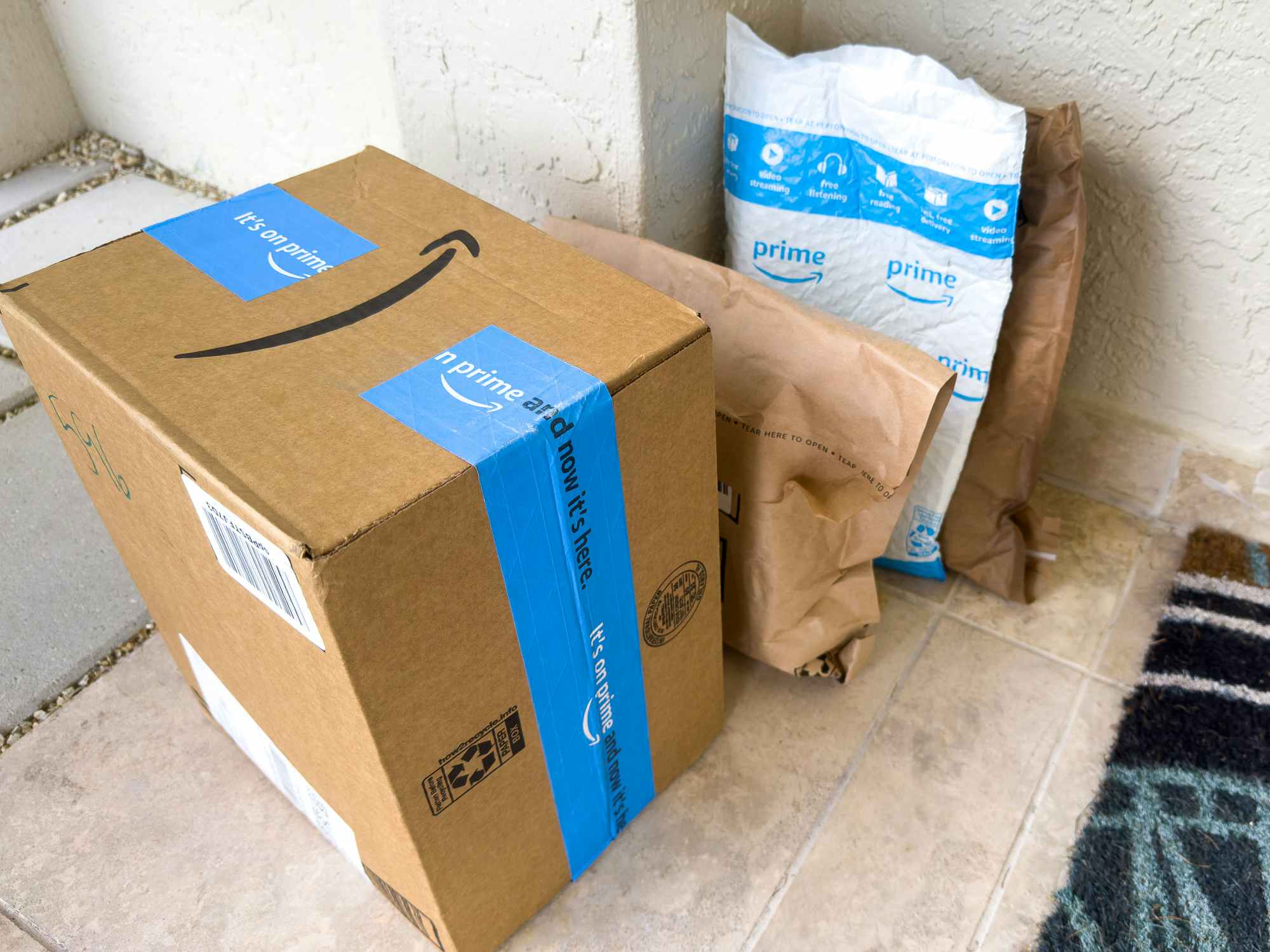 A pile of Amazon boxes and envelopes on the porch