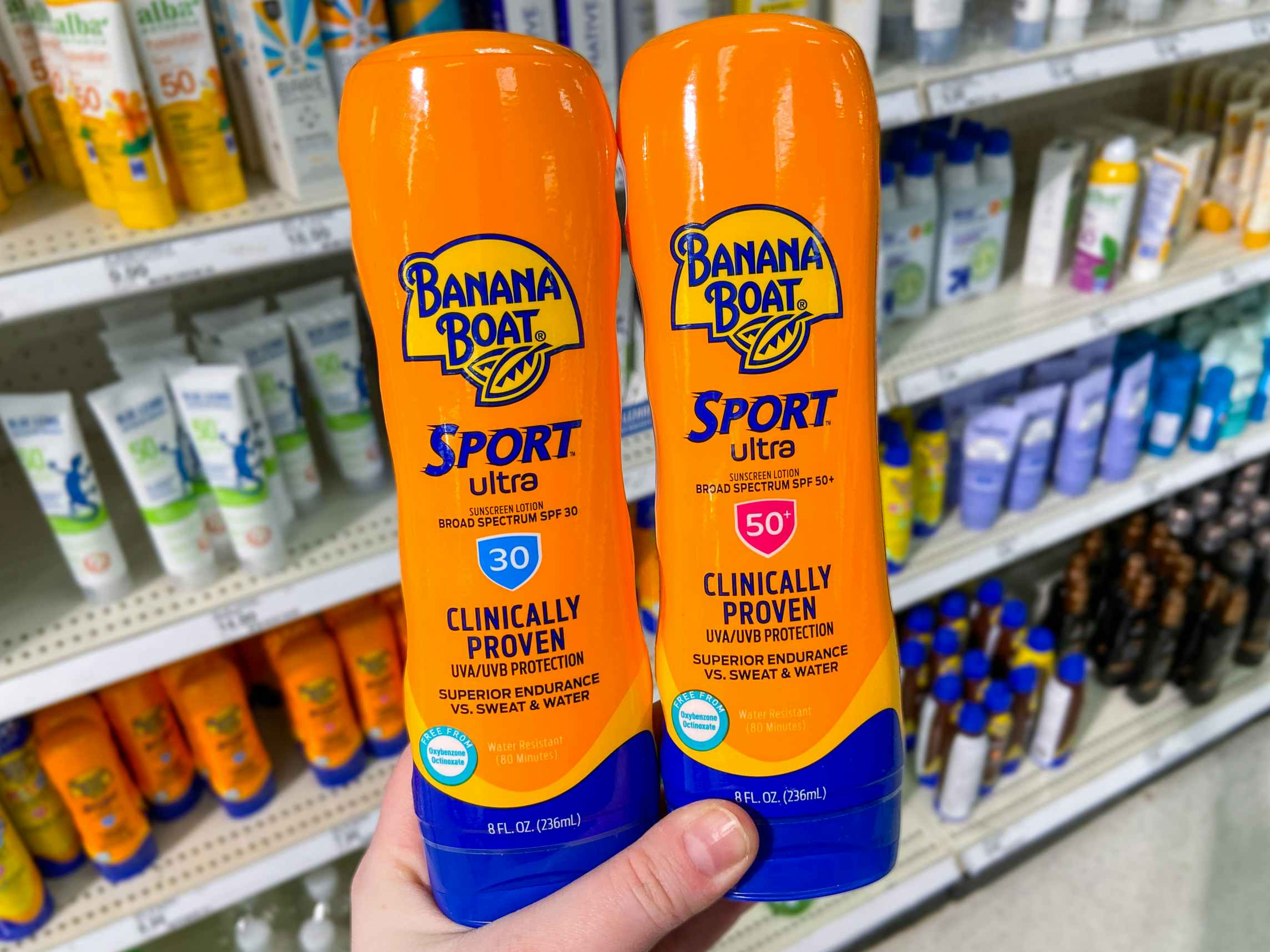 hand holding two bottles of banana boat sunscreen lotion