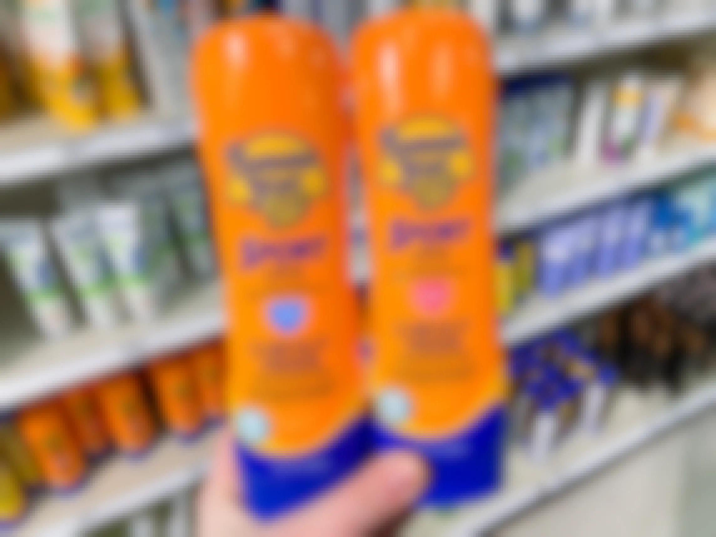 hand holding two bottles of banana boat sunscreen lotion