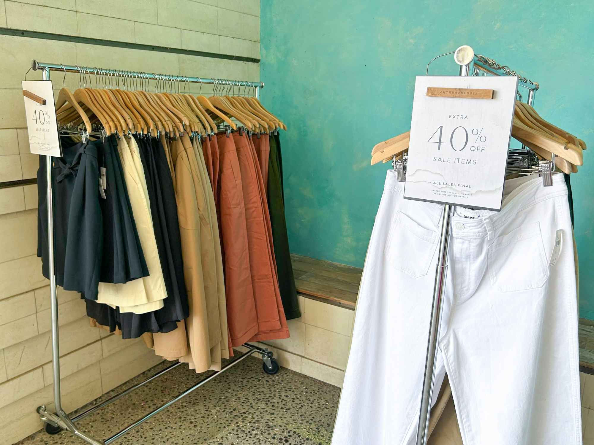 Clothing hanging on a rack at Anthropologie with signs advertising 40% off sale items