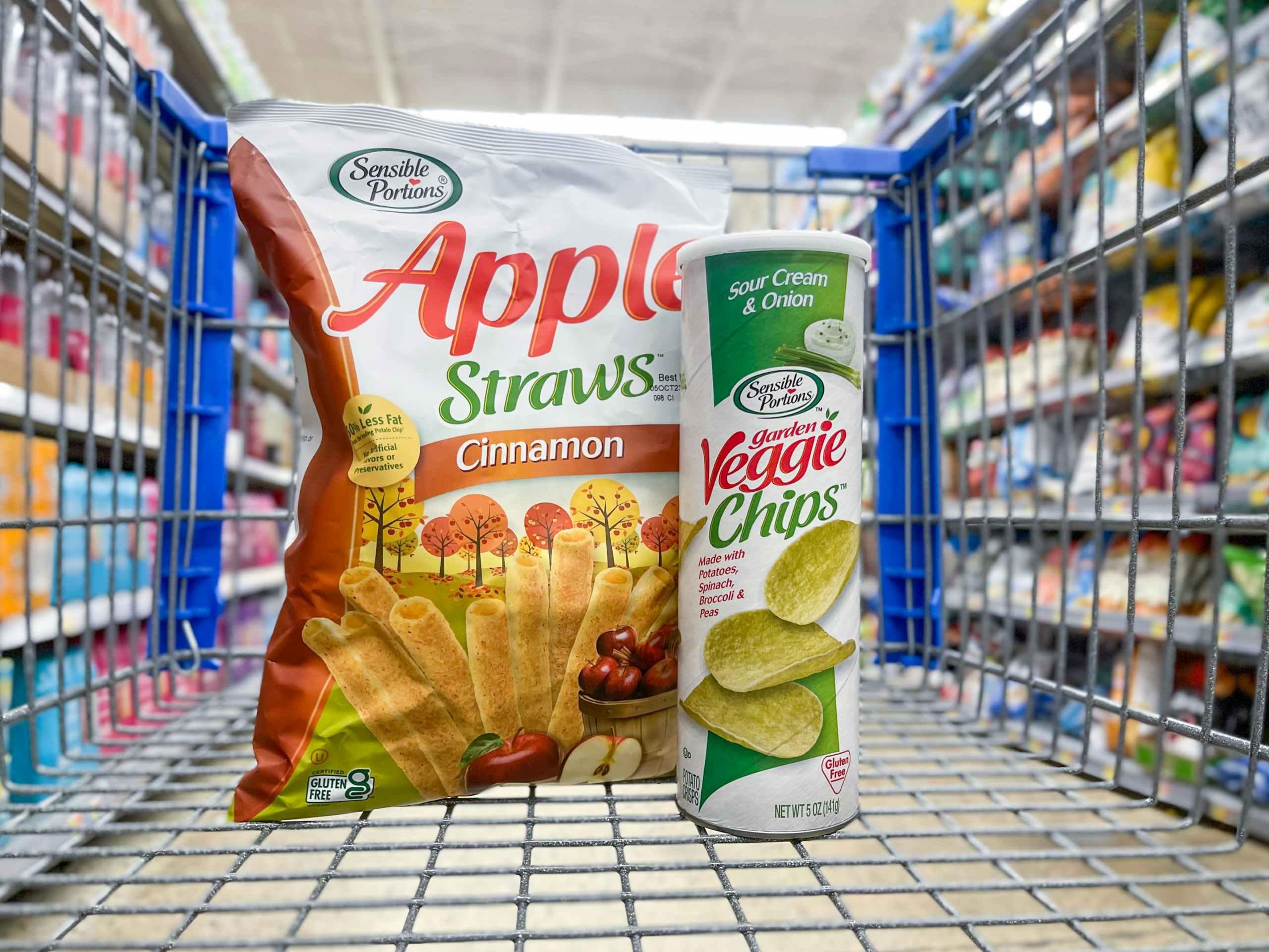 An Apple Straws bag and a Veggie Chips can sitting in a store cart.