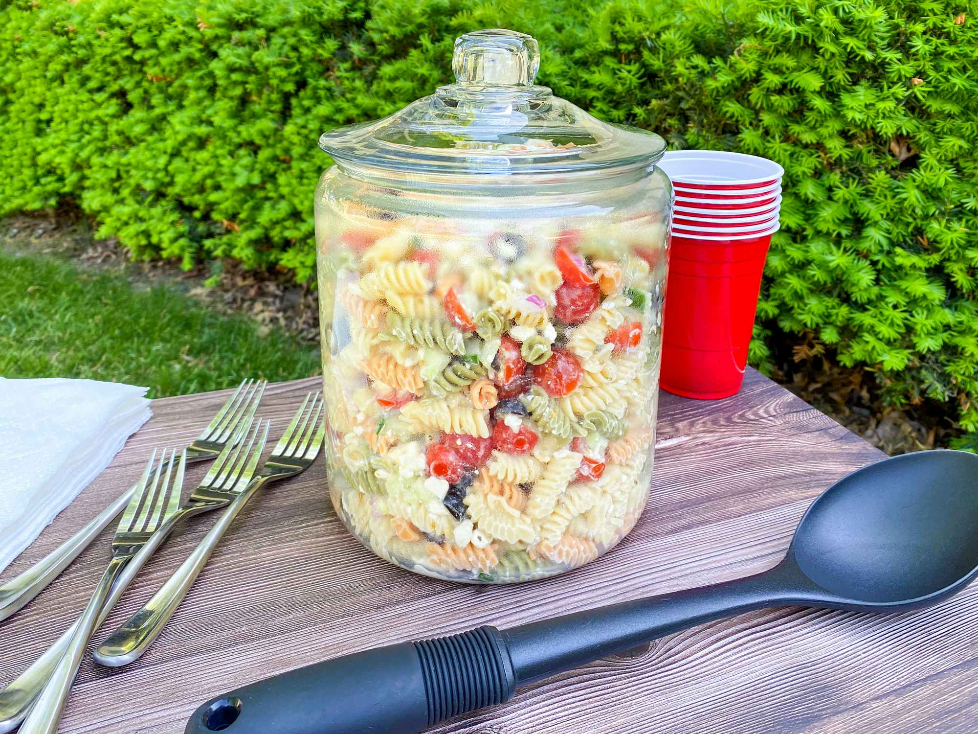 pasta salad in a lidded glass jar for a potluck