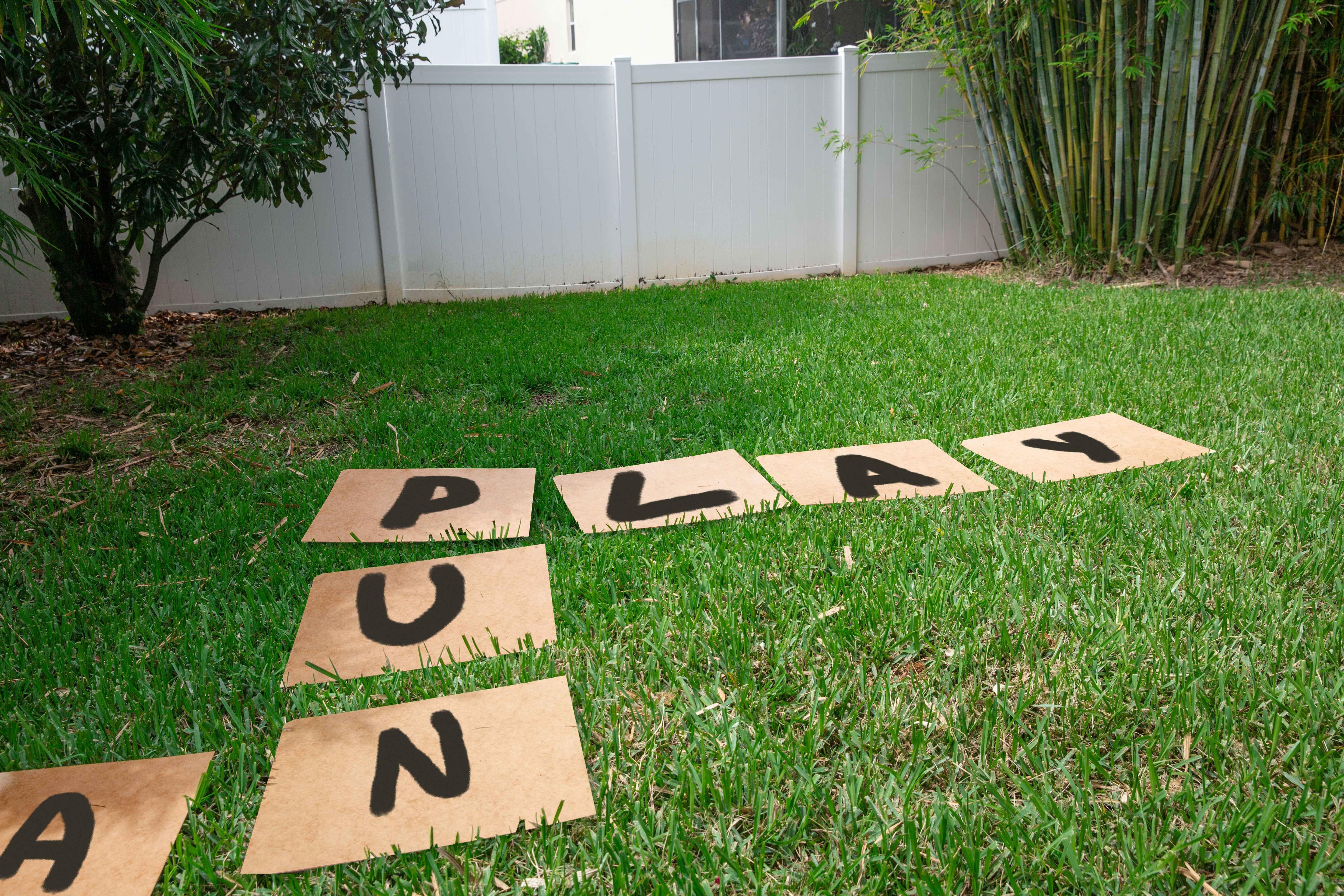large carboard squares in a grassy backyard