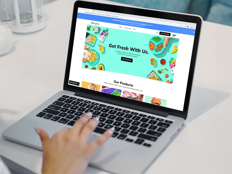a person looking at the little spoon website on their macbook