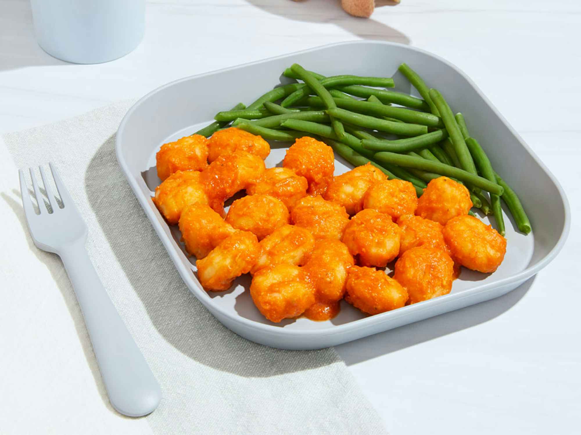 gnocchi from nurture life on a plate next to green beans