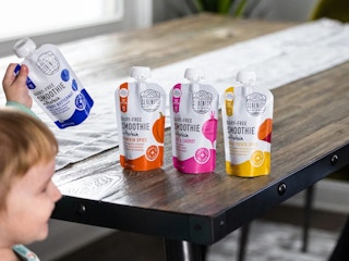 a child holding a serenity kids smoothie pouch 
