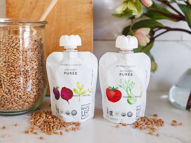 two white leaf provision pouches sitting on a countertop
