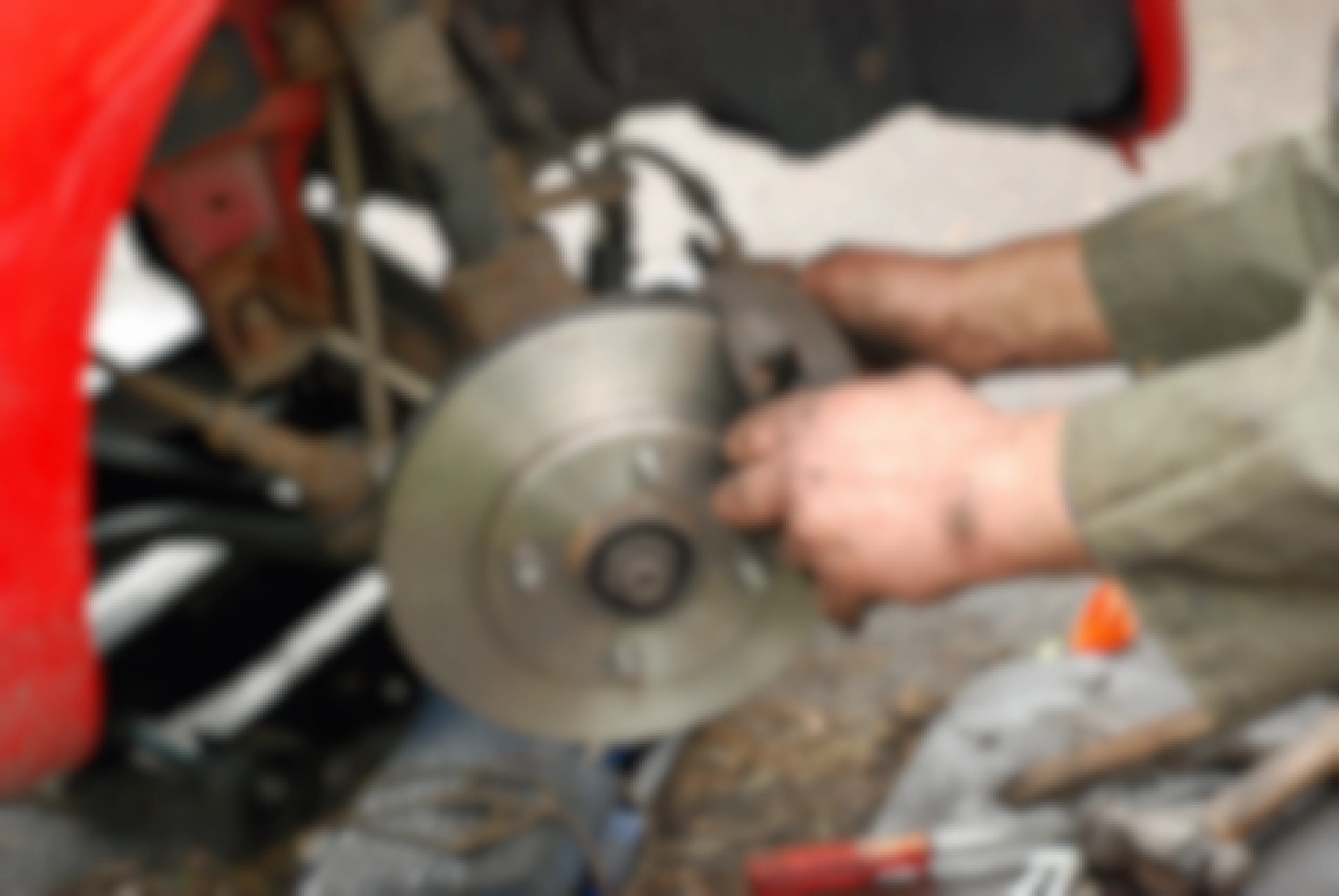 A mechanic repairing a car brake