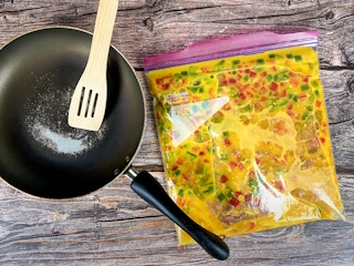 bag of eggs and omelet, pan, and spatula