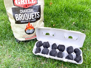 charcoal briquets in a cardboard egg carton for starting a campfirefire