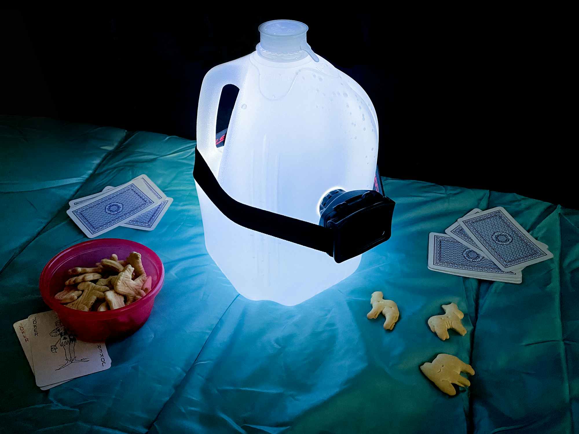 a gallon jug of water with a headlamp to make a diy lantern for camping