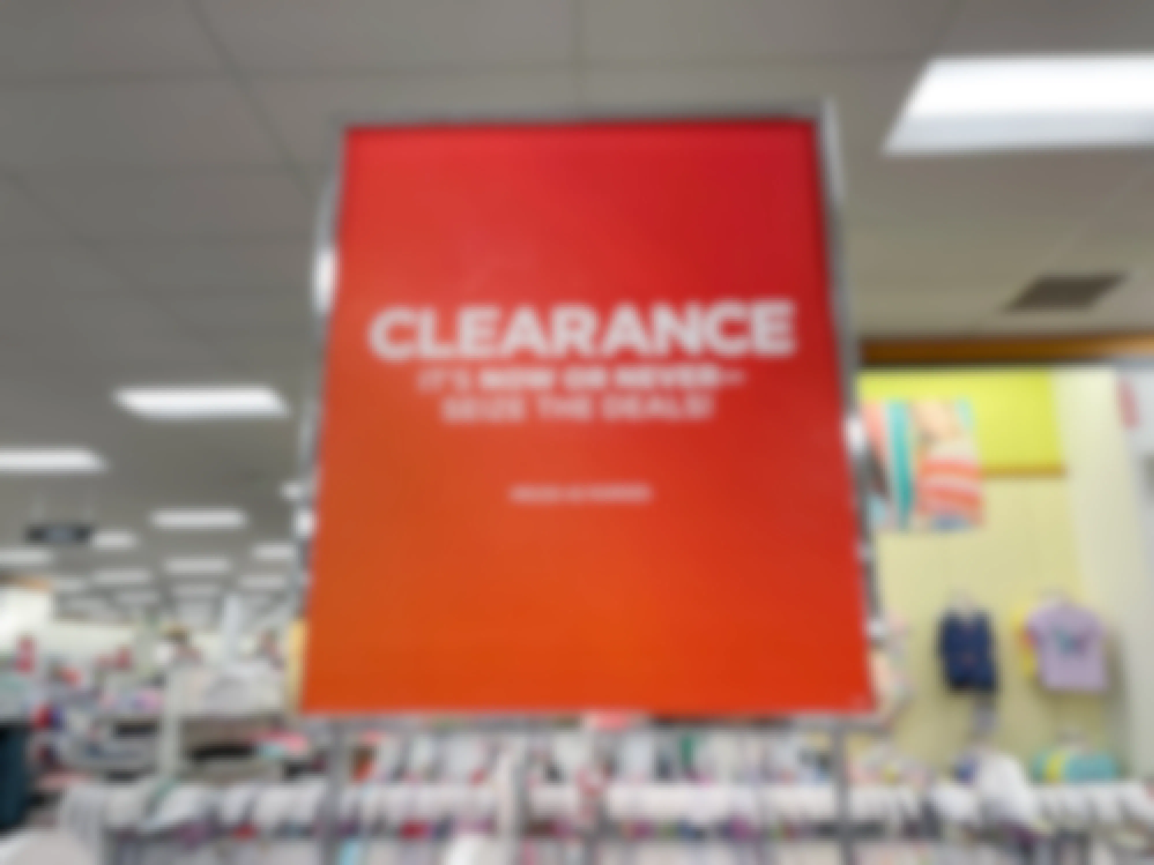 Clearance sign attached to a store rack with clothes in the background